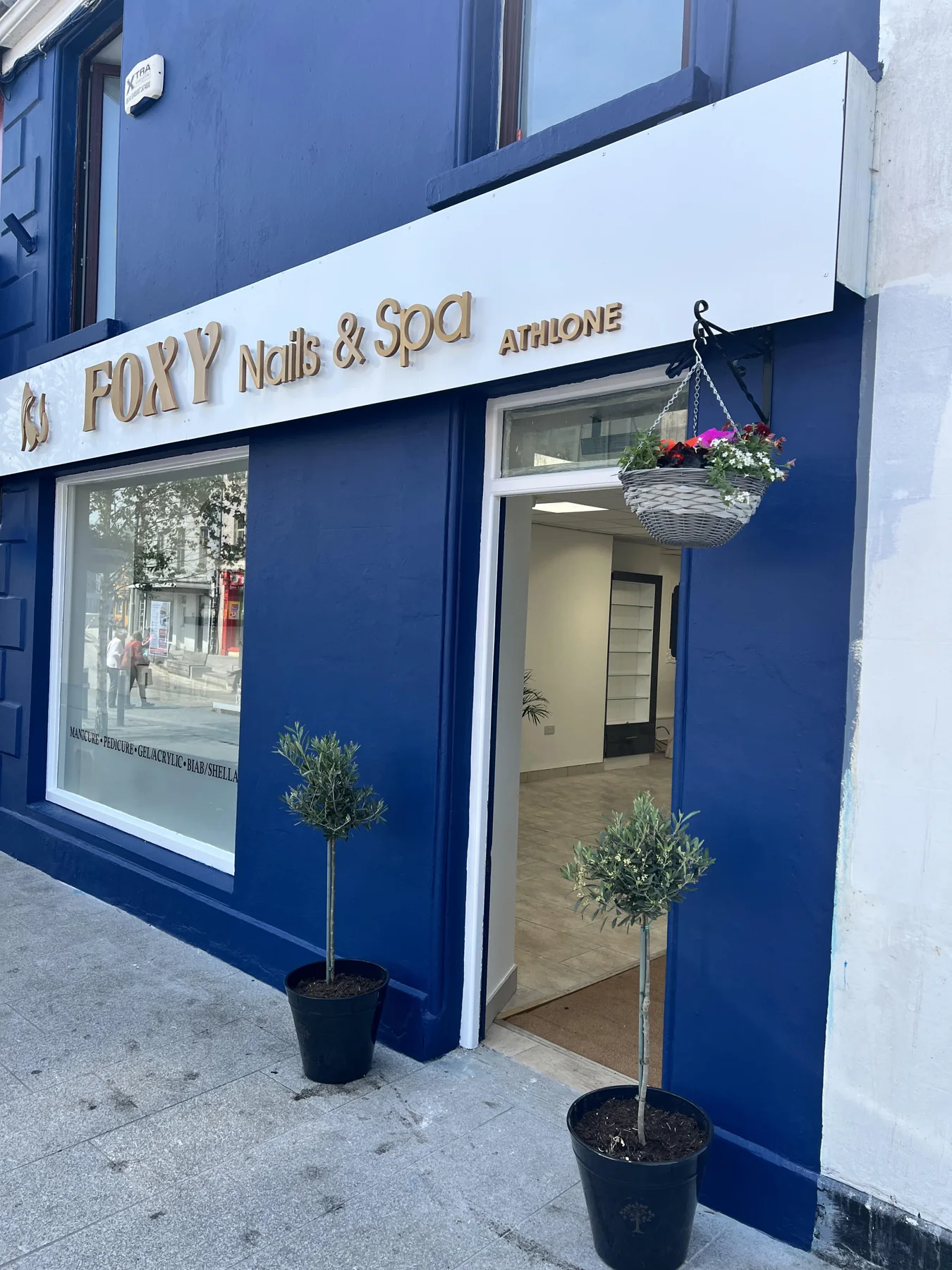 Blue Foxy Nails and Spa storefront in Athlone with gold signage and plants beside the entrance